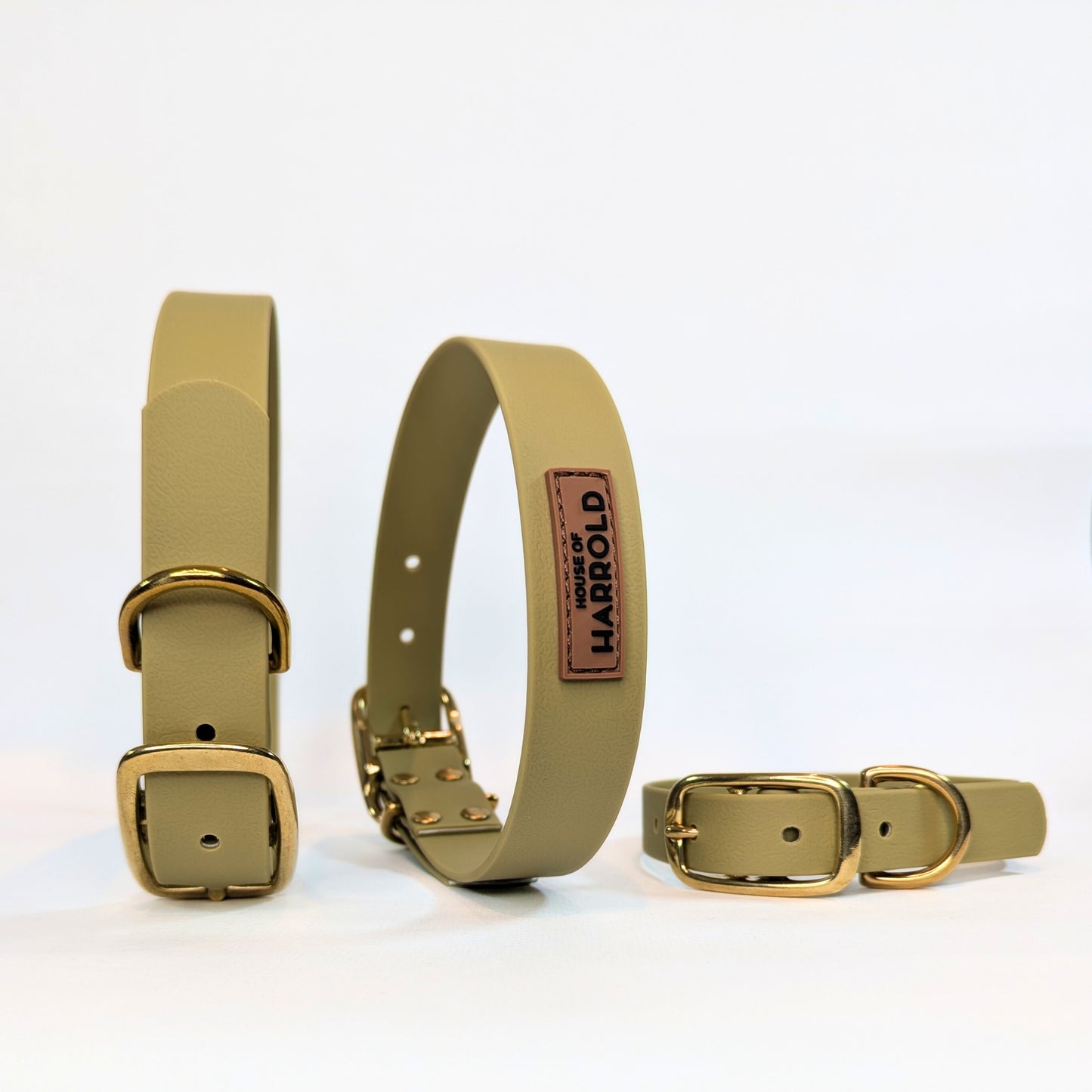 Three green vegan dog collars with brass buckles on a white background, featuring the brand 'House Of Harrold'.