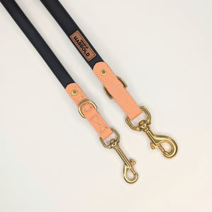 Black dog leashes with tan leather accents and polished brass clips featuring House of Harrold durable anti-pull design